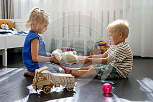 Kids are fighting over a toy. conflict between sister and brother. sibling relationships