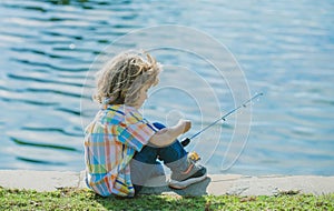 Kids fisher. Child fishing on the lake. Boy with spinner at river. Portrait of excited boy fishing. Boy at jetty with