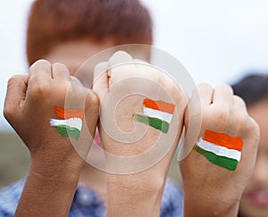 Kids fist hands painted with Indian falg during independence day or republic day celebration - concept showing of