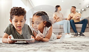 Kids on floor with tablet in living room, watching fun and educational videos or playing game online with parents on