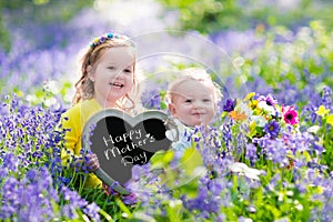 Kids with flowers and chalk board