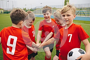 Kids on Football Soccer Team Putting Hands in. Boys Football School Team Huddling