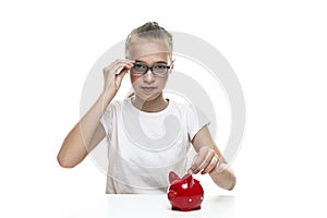Kids Frugal Concepts. Blond Teenager Girl Posing With Coins and Piggy Bank. Storing up Money With Moneybox For Savings