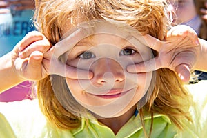 Kids funny face closeup. Childhood, leisure and children concept. Happy kid having fun and making faces outdoors