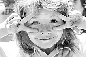 Kids funny face closeup. Childhood, leisure and children concept. Happy kid having fun and making faces outdoors
