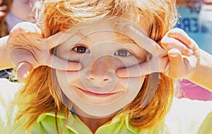 Kids funny face closeup. Childhood, leisure and children concept. Happy kid having fun and making faces outdoors