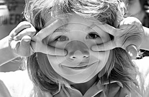 Kids funny face closeup. Childhood, leisure and children concept. Happy kid having fun and making faces outdoors