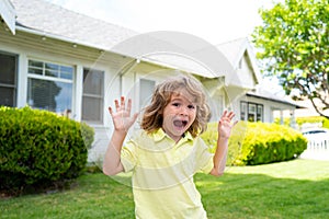 Kids funny face. Leisure and children concept. Happy kid having fun and making faces outdoors. Little boy with funny