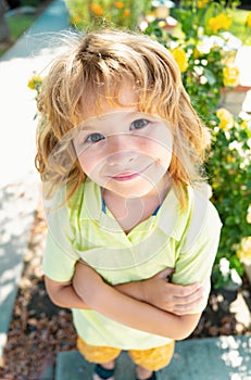 Kids funny face. Summer, childhood, leisure and children concept. Happy kid having fun and making faces outdoors on a