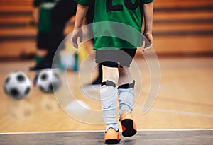 Kids futsal training. Indoor soccer players training with balls.