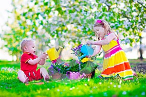Kids in a garden with blooming cherry trees