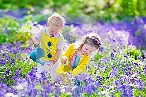 Kids in a garden with bluebell flowers
