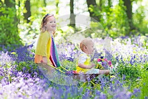 Kids in a garden with bluebell flowers