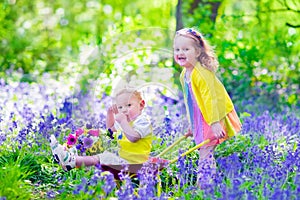 Kids in a garden with bluebell flowers