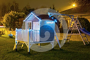 Kids garden house illuminated at night