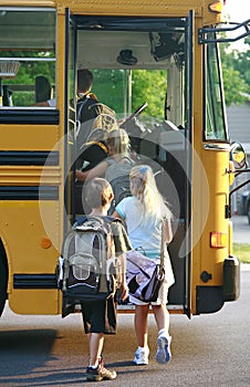 Kids Getting on School Bus photo