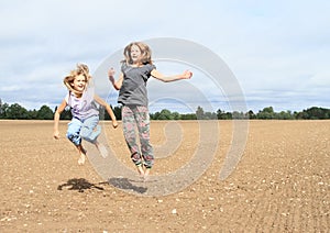 Kids - girls jumping on field