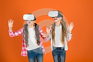 Kids girls play virtual reality game. Friends interact in vr. Explore alternative reality. Future is present. Cyber