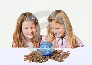 Kids - girls with saving pig full of money