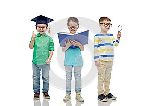 Kids in glasses with book, lens and bachelor hat