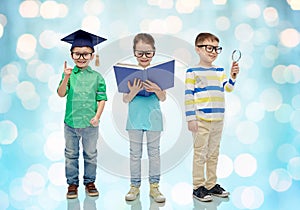 Kids in glasses with book, lense and bachelor hat