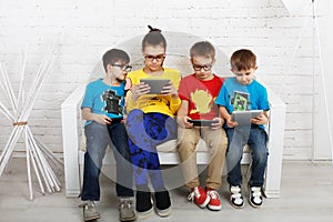Kids in glasses with gadgets, computer addiction