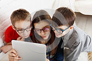 Kids in glasses with tablet, computer addiction