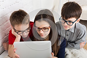 Kids in glasses with tablet, computer addiction