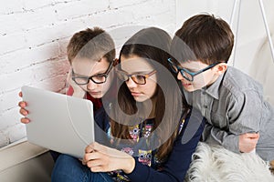 Kids in glasses with tablet, computer addiction