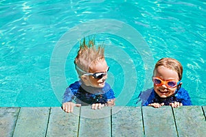 Kids in goggles have fun at poolside in swimming pool