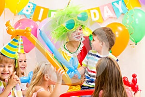 Kids group and clown celebrating birthday party