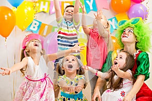 Kids group with clown celebrating birthday party