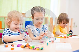 Kids group doing arts and crafts in day care centre