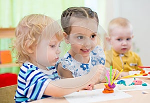 Kids group doing arts and crafts in kindergarten