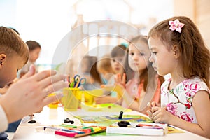 Kids group learning arts and crafts in daycare centre