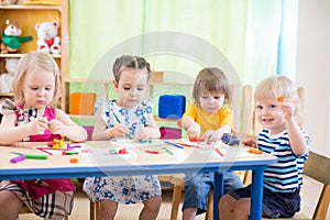 Kids group learning arts and crafts in kindergarten with interest