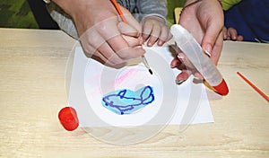 Kids group making arts and crafts in kindergarten. Children spending time in day care centre with the great interest