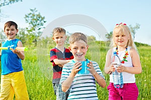 Kids group with toy water guns