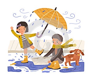 Kids in gumboots playing under rain. Happy cute children with paper boat and umbrella in rainy weather. Boy, girl and