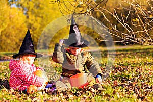 Kids in halloween costume play at autumn park