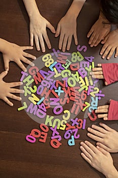 Kids hands holding Educational colorful numeral figures. Show numbers concept