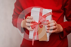 Kids Hands Holding Gift Christmas Box. Top view. Copy space for Text.