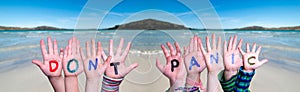 Kids Hands Holding Word Do Not Panic, Ocean Background