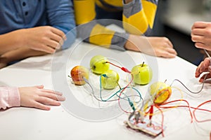 Kids hands with invention kit at robotics school