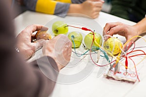 Kids hands with invention kit at robotics school photo