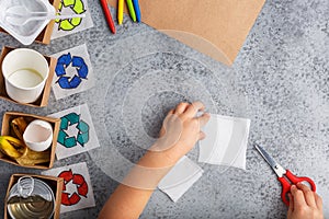 Kids hands is making recycling game kid is drawing recycle sign paper craft