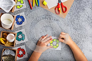 Kids hands is making recycling game kid is drawing recycle sign paper craft