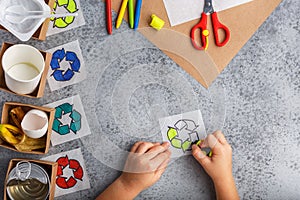 Kids hands is making recycling game kid is drawing recycle sign paper craft