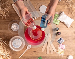 Kids hands making slime toy at home