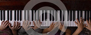 Kids hands playing on the piano, online education